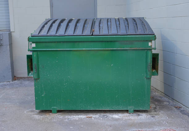 large green commercial dumpster for trash and recycling